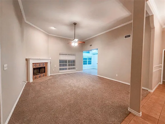 a view of empty room with a fireplace