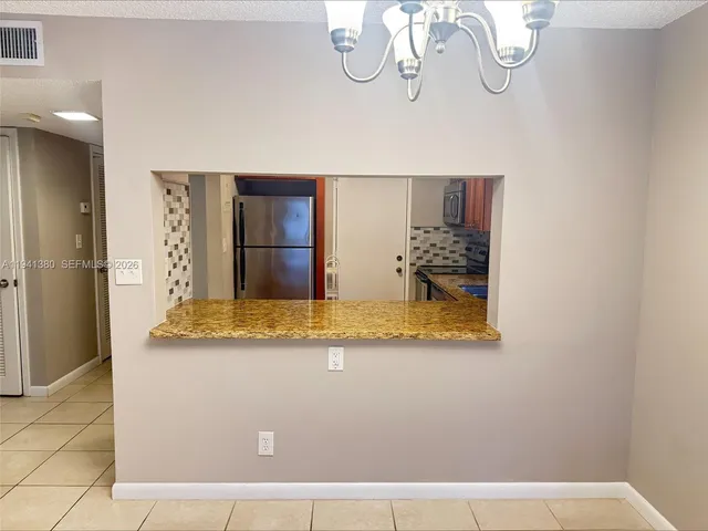 a view of a living room and kitchen with furniture