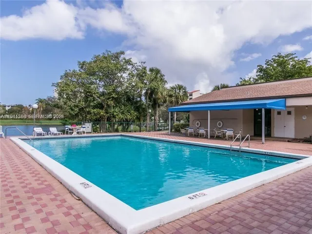 a view of a swimming pool with a patio