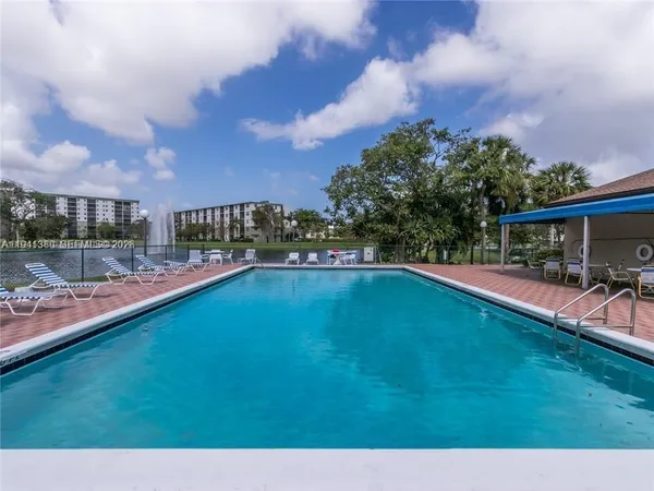 a view of a swimming pool and a yard