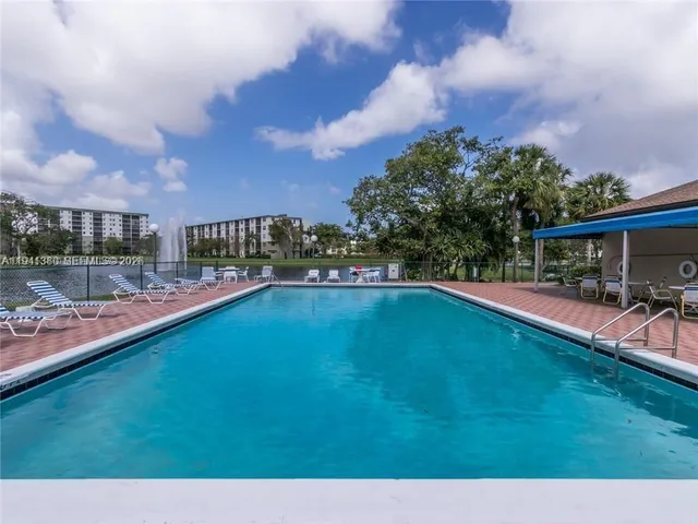 a view of a swimming pool and a yard