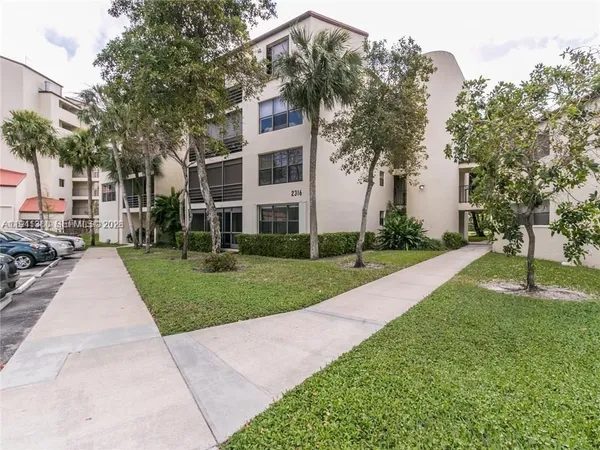 a view of a building with a yard