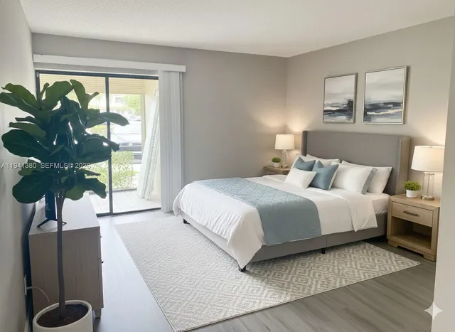 a bedroom with a large bed and a potted plant