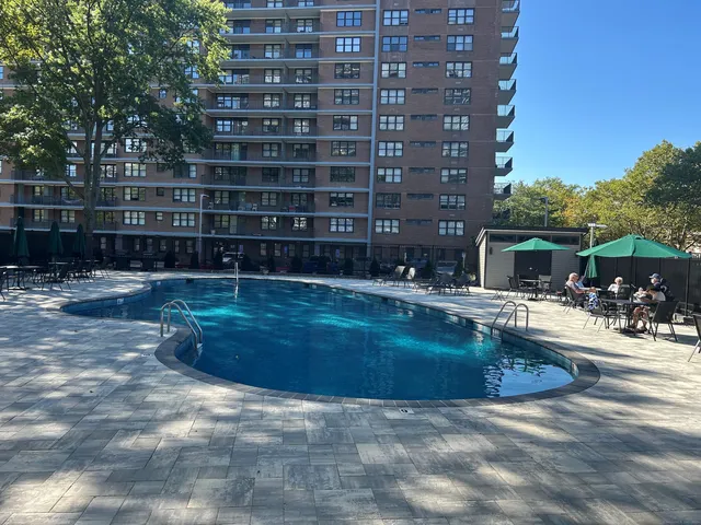 a view of swimming pool with outdoor seating