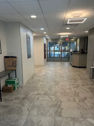 a view of a hall with an chairs