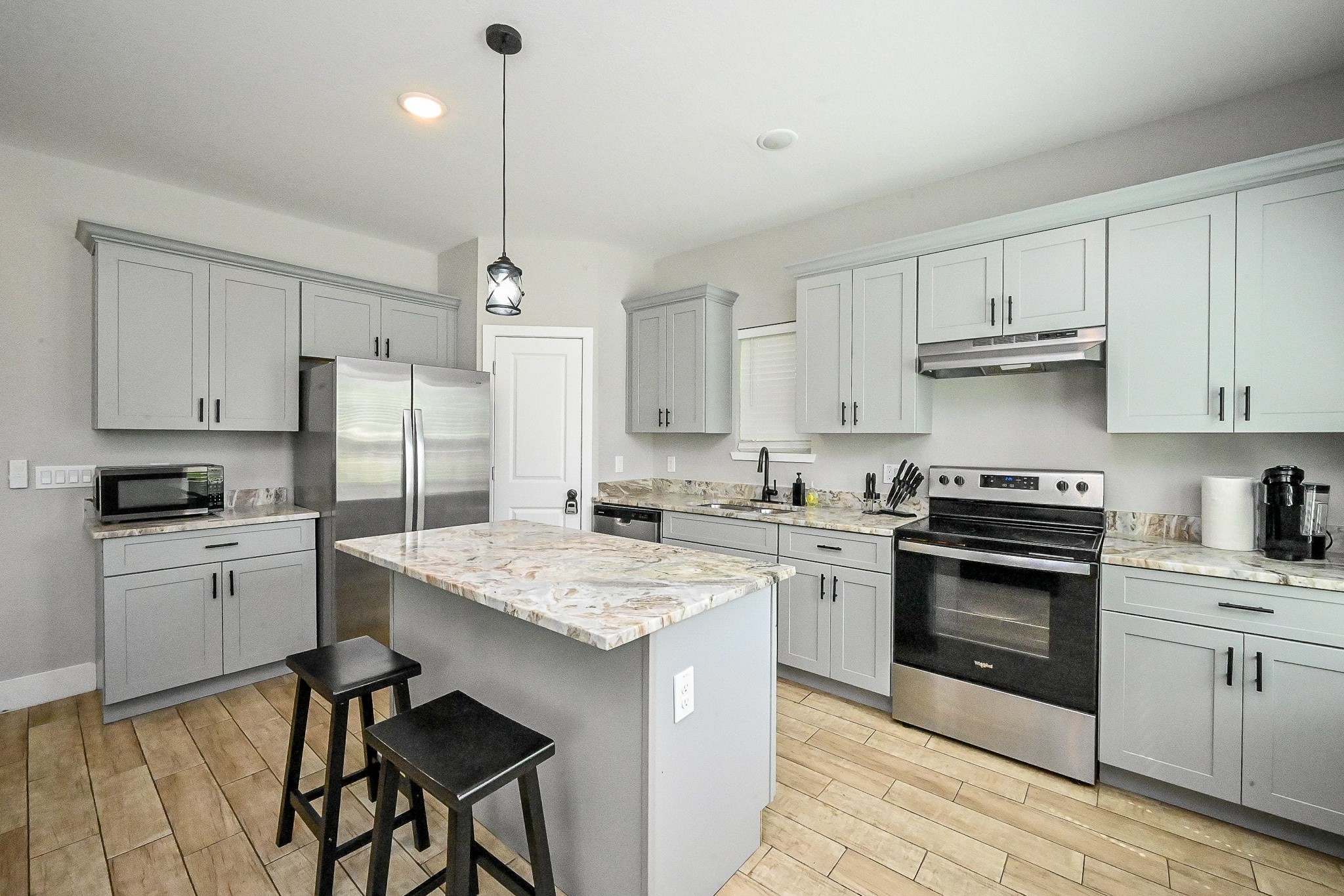 5007 Briscoe Street, Unit B Houston, TX 77033 - Photo 4 of 18 Open Concept Kitchen with granite countertops and stainless steel appliances