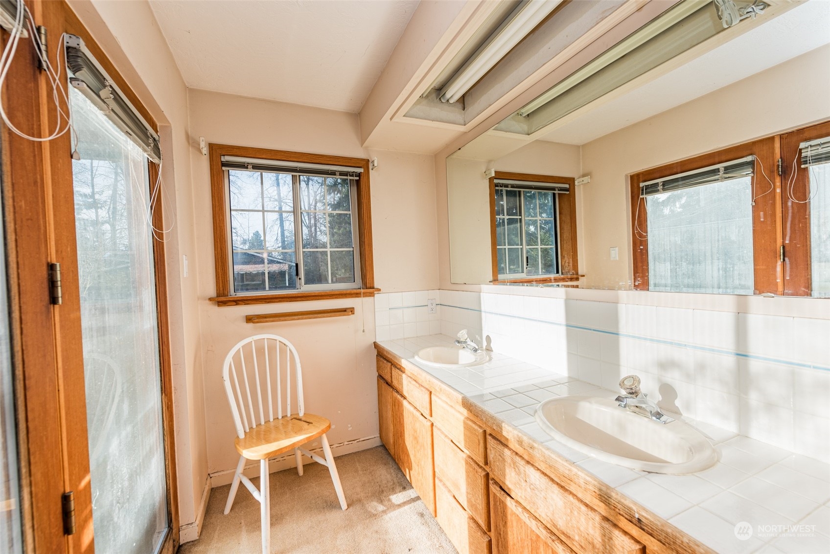 970 River Road Sequim, WA 98382 - Photo 15 of 40 a bathroom with a granite countertop sink and a large mirror