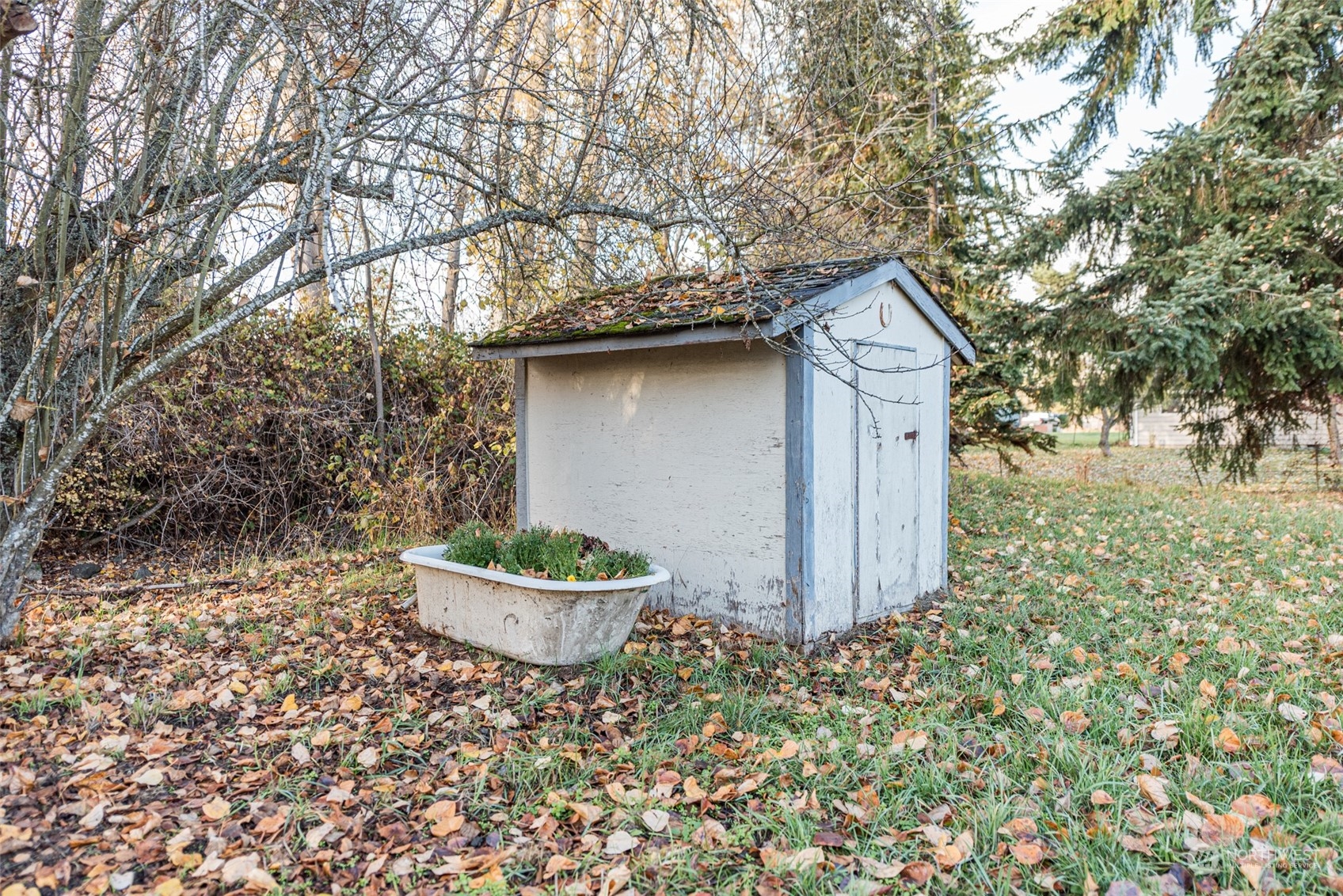 970 River Road Sequim, WA 98382 - Photo 30 of 40 a backyard of a house with a table and chair