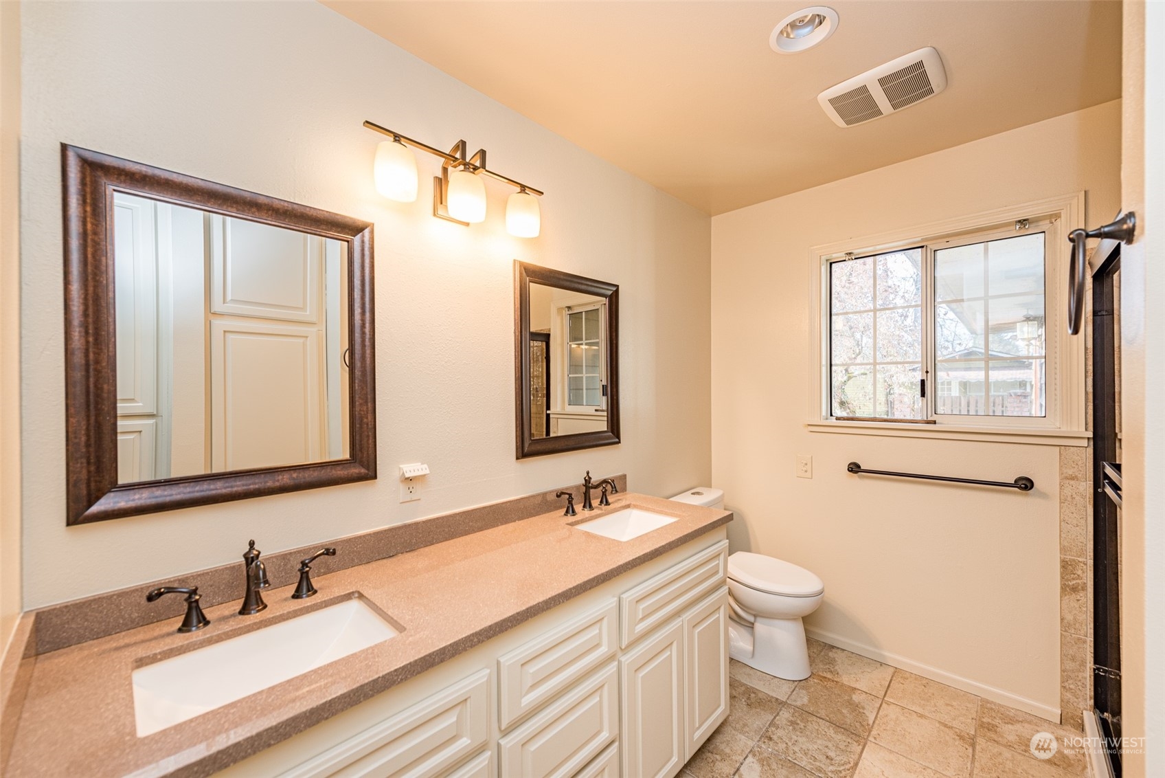 970 River Road Sequim, WA 98382 - Photo 9 of 40 a bathroom with double vanity sink a mirror and a toilet