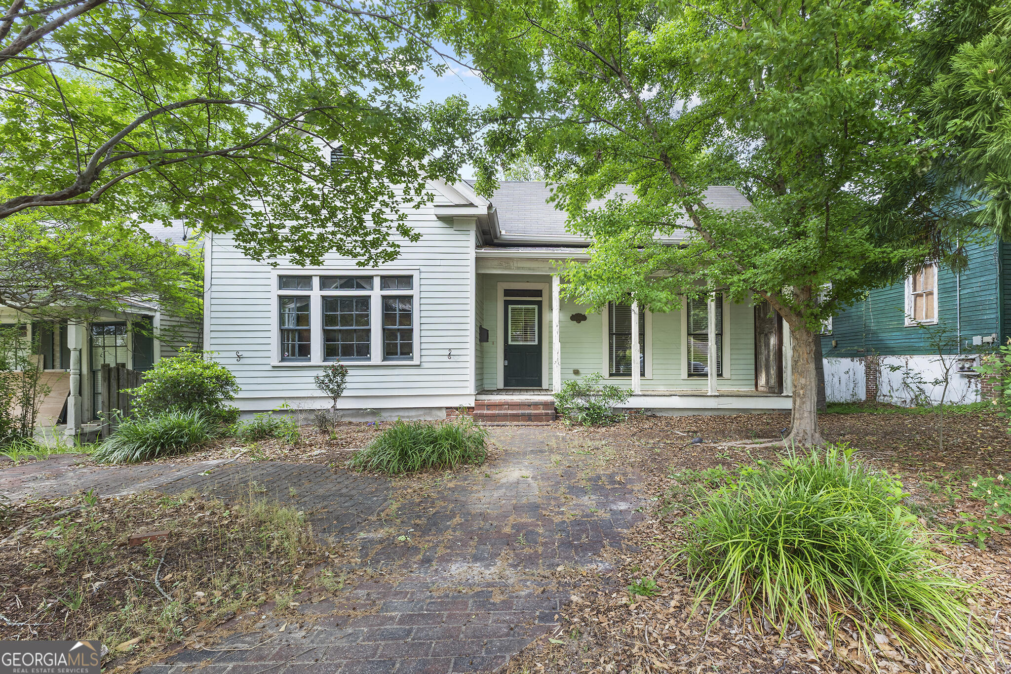 1469 Chestnut Street Macon, GA 31201 - Photo 1 of 26 a front view of a house with garden and trees