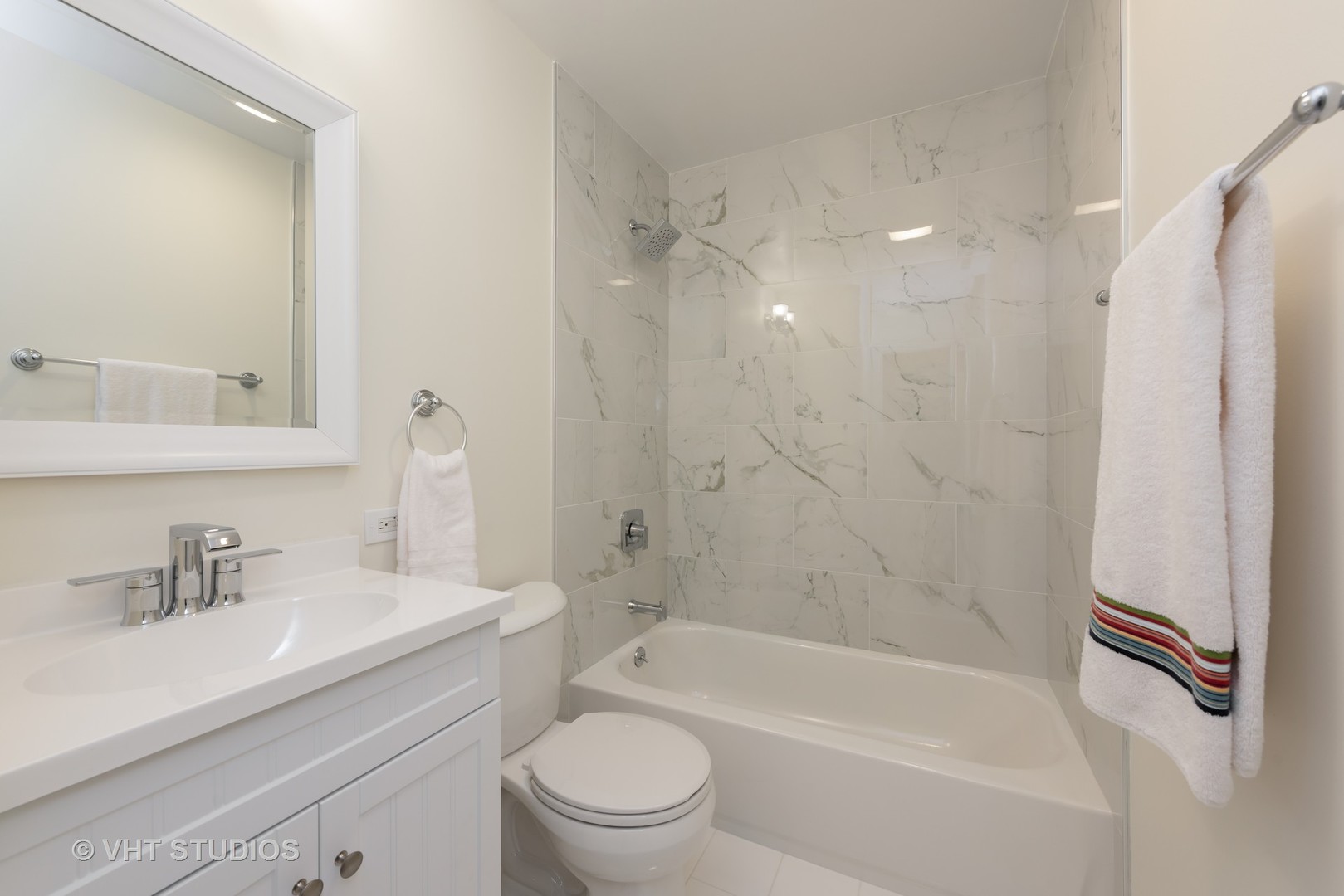 104 West Oak Street, Unit 2W Chicago, IL 60610 - Photo 12 of 17 a bathroom with a bathtub shower sink vanity mirror and toilet