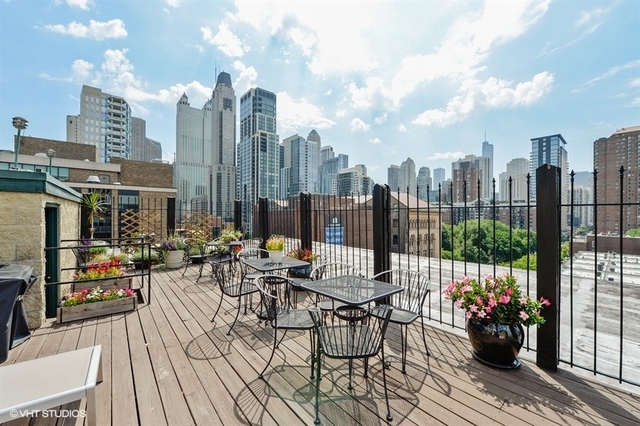 104 West Oak Street, Unit 2W Chicago, IL 60610 - Photo 17 of 17 a view of a terrace with furniture and garden