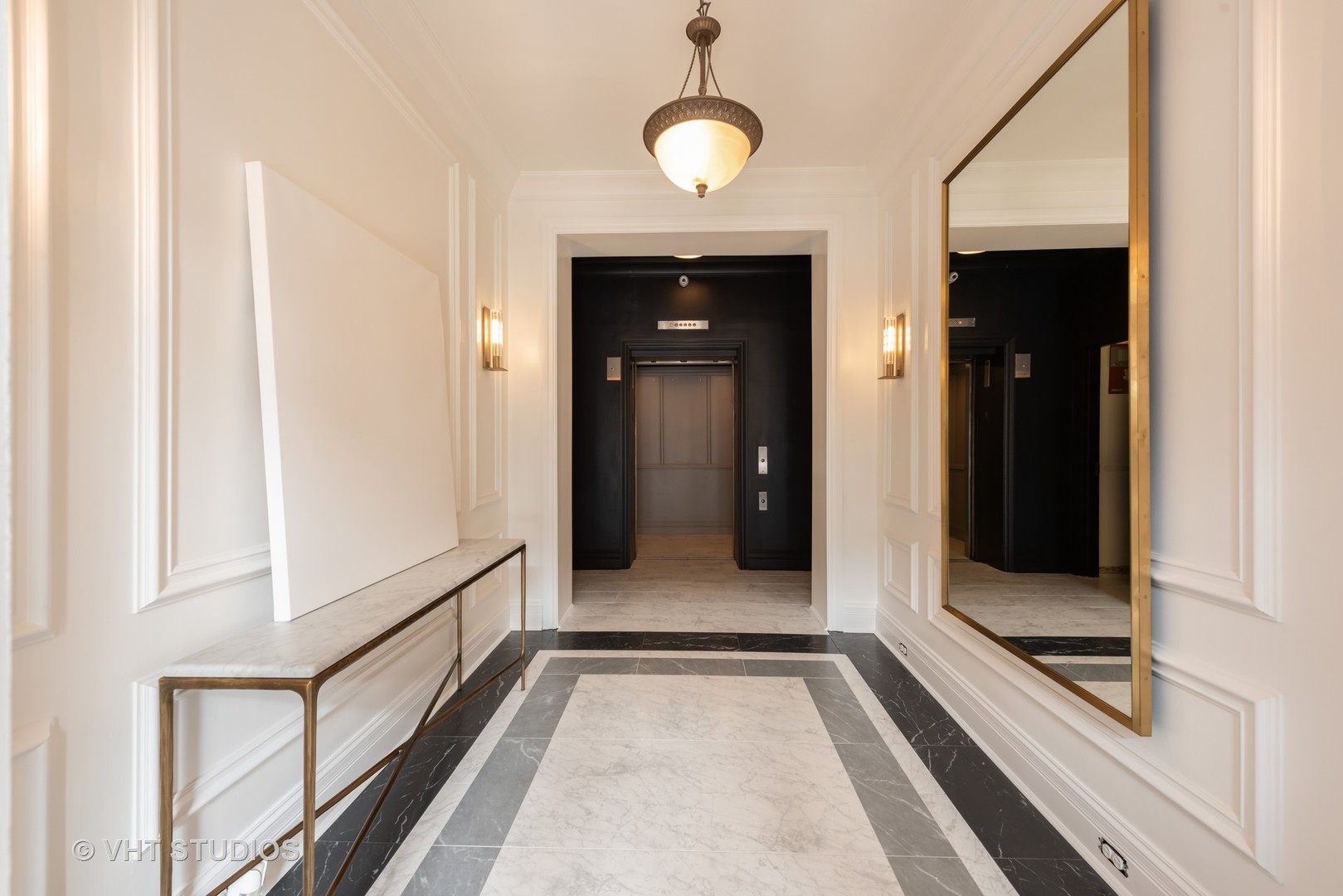 104 West Oak Street, Unit 2W Chicago, IL 60610 - Photo 3 of 17 a view of a hallway with wooden floor and staircase