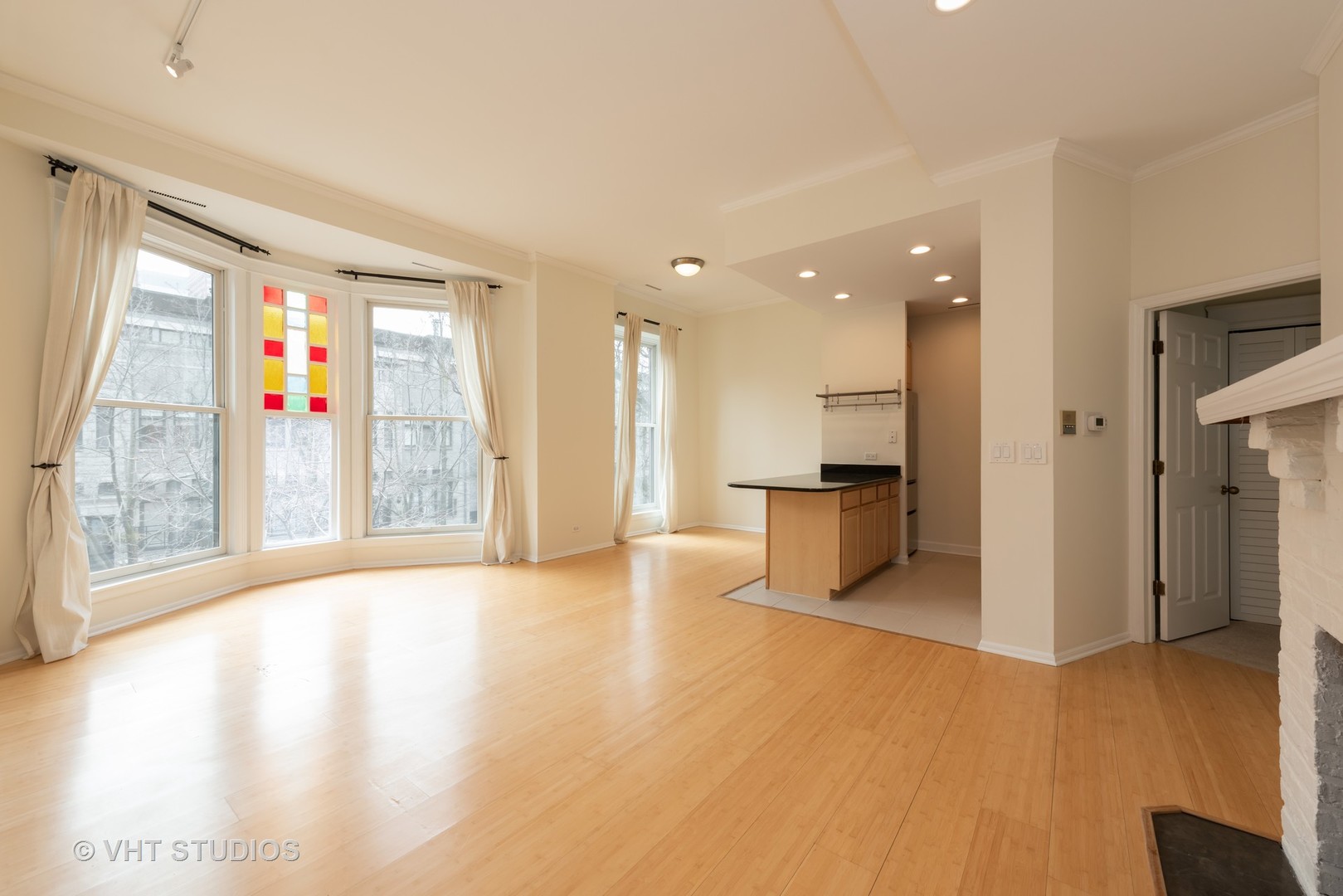 104 West Oak Street, Unit 2W Chicago, IL 60610 - Photo 5 of 17 a view of an empty room with window and wooden floor