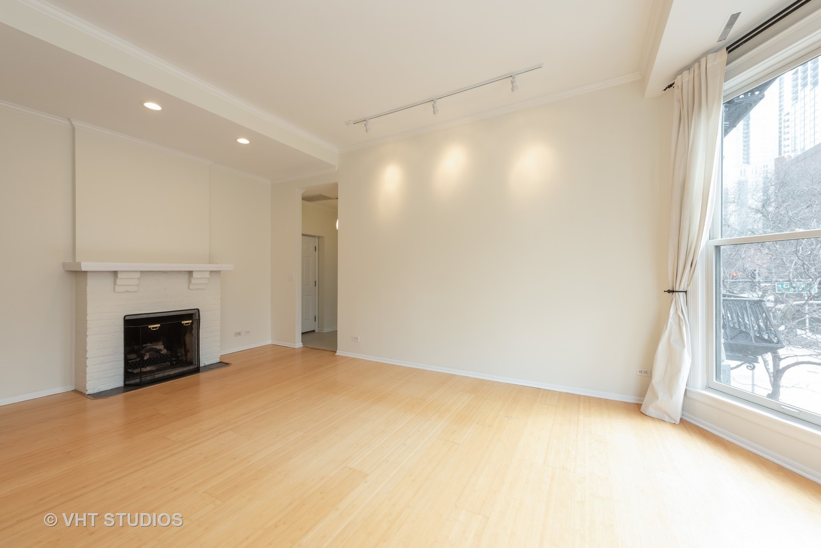 104 West Oak Street, Unit 2W Chicago, IL 60610 - Photo 7 of 17 a view of empty room with a fireplace and windows