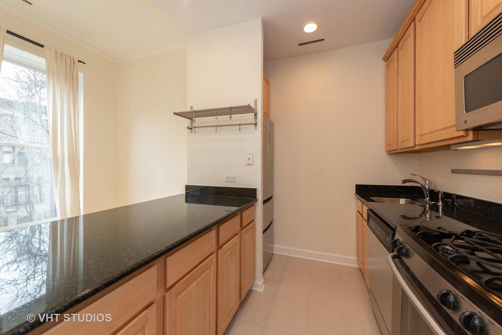 104 West Oak Street, Unit 2W Chicago, IL 60610 - Photo 8 of 17 a kitchen with granite countertop a sink and a stove