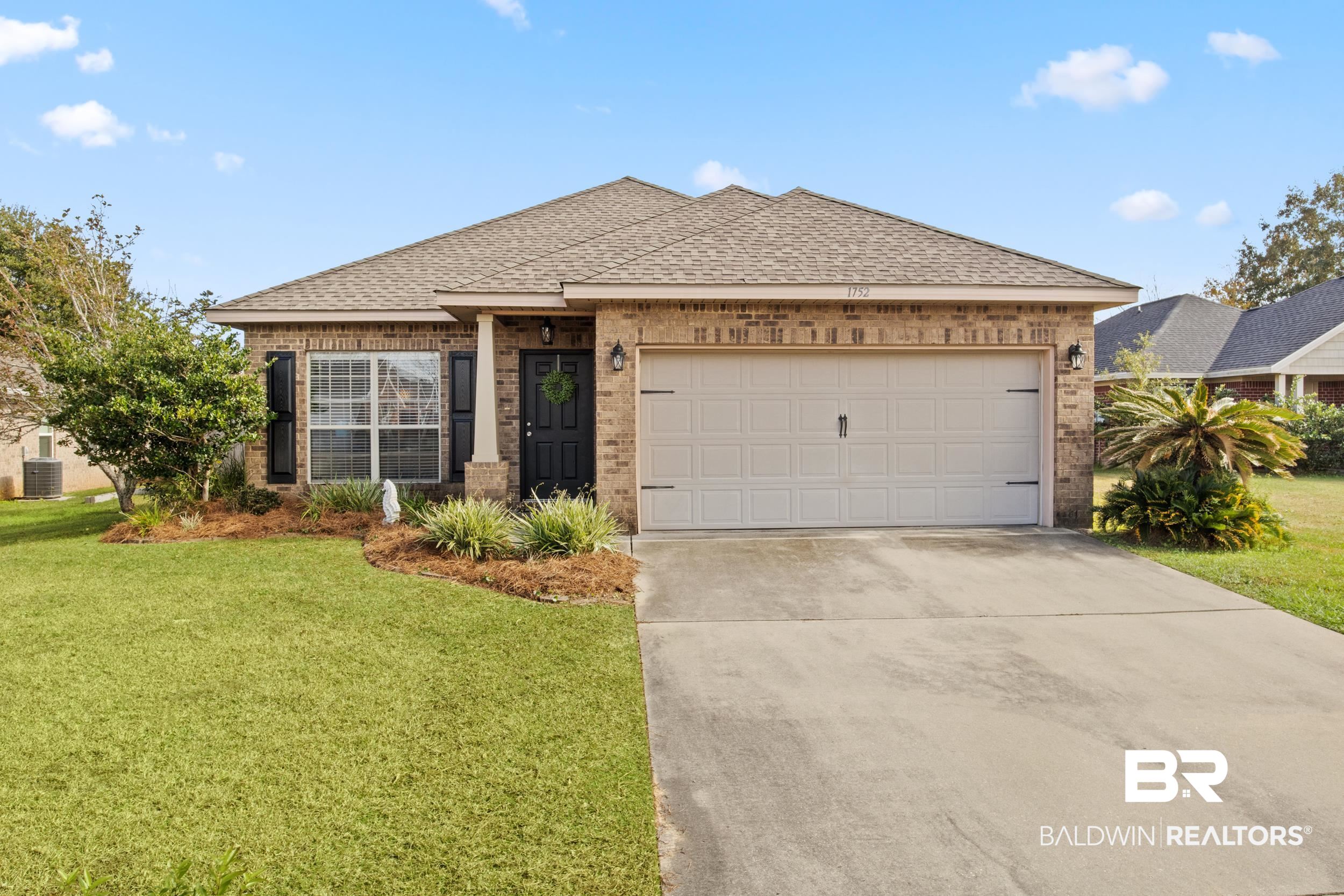 1752 Abbey Loop Foley, AL 36535 - Photo 20 of 21 View of front facade with a garage and a front lawn