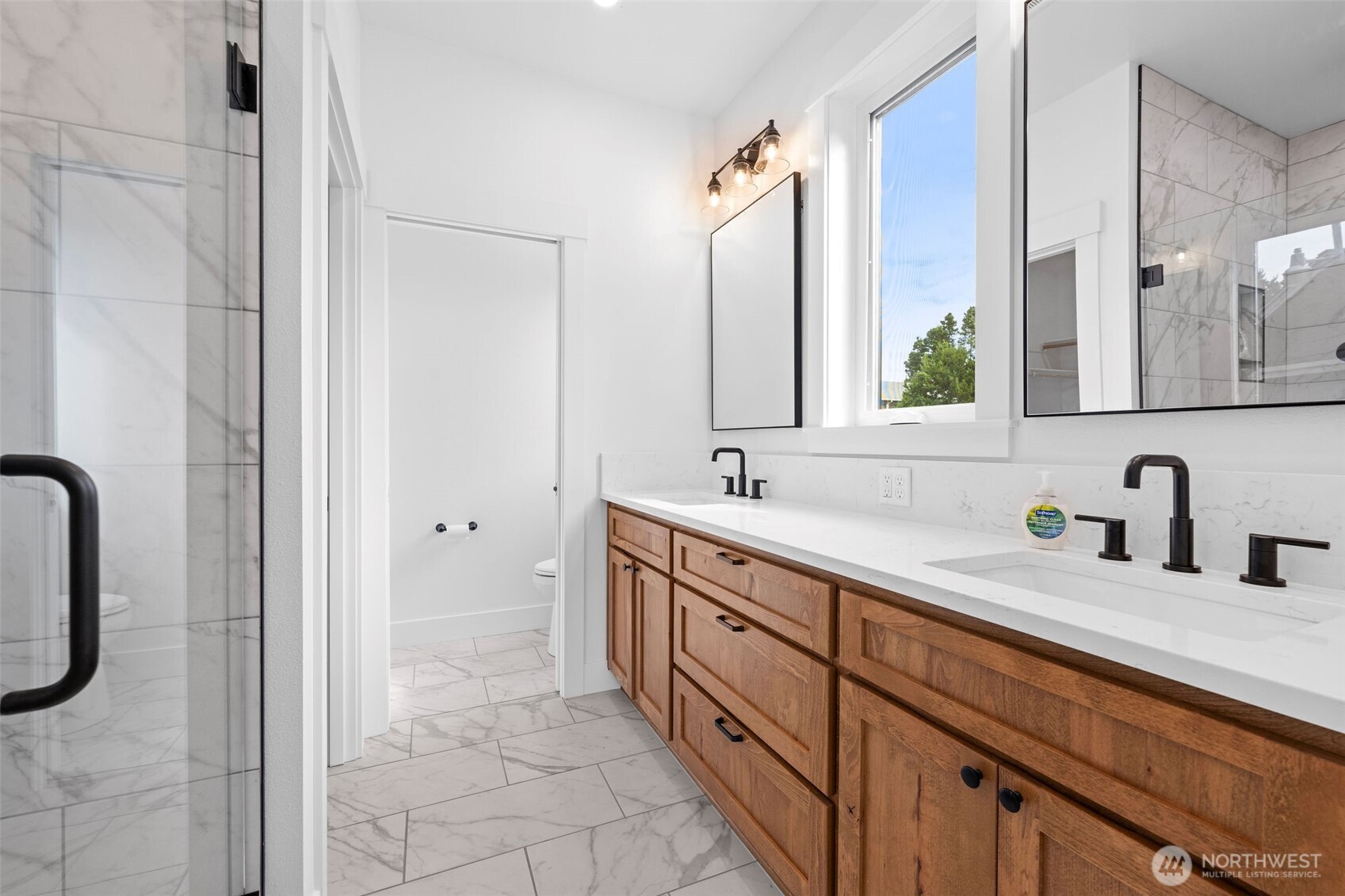 1306 195th Street Long Beach, WA 98631 - Photo 12 of 24 a bathroom with a double vanity sink mirror and bathtub