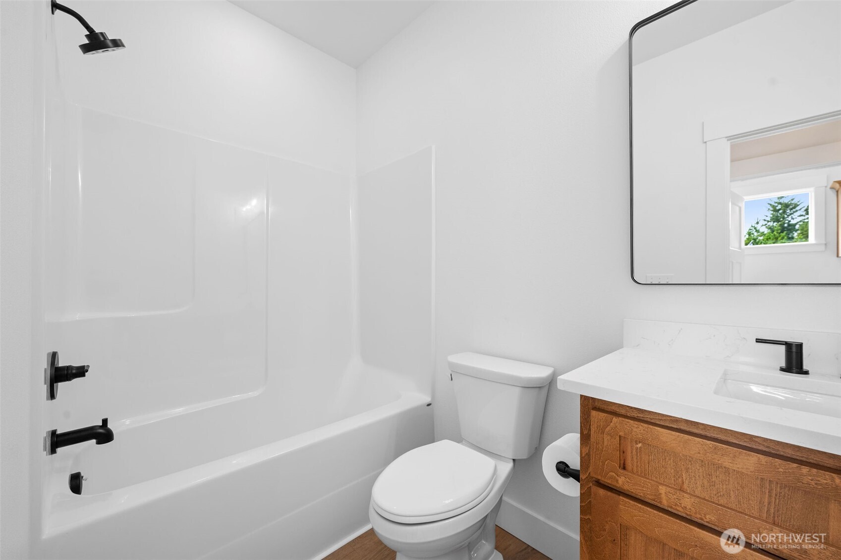 1306 195th Street Long Beach, WA 98631 - Photo 17 of 24 a white toilet sitting next to a bath tub