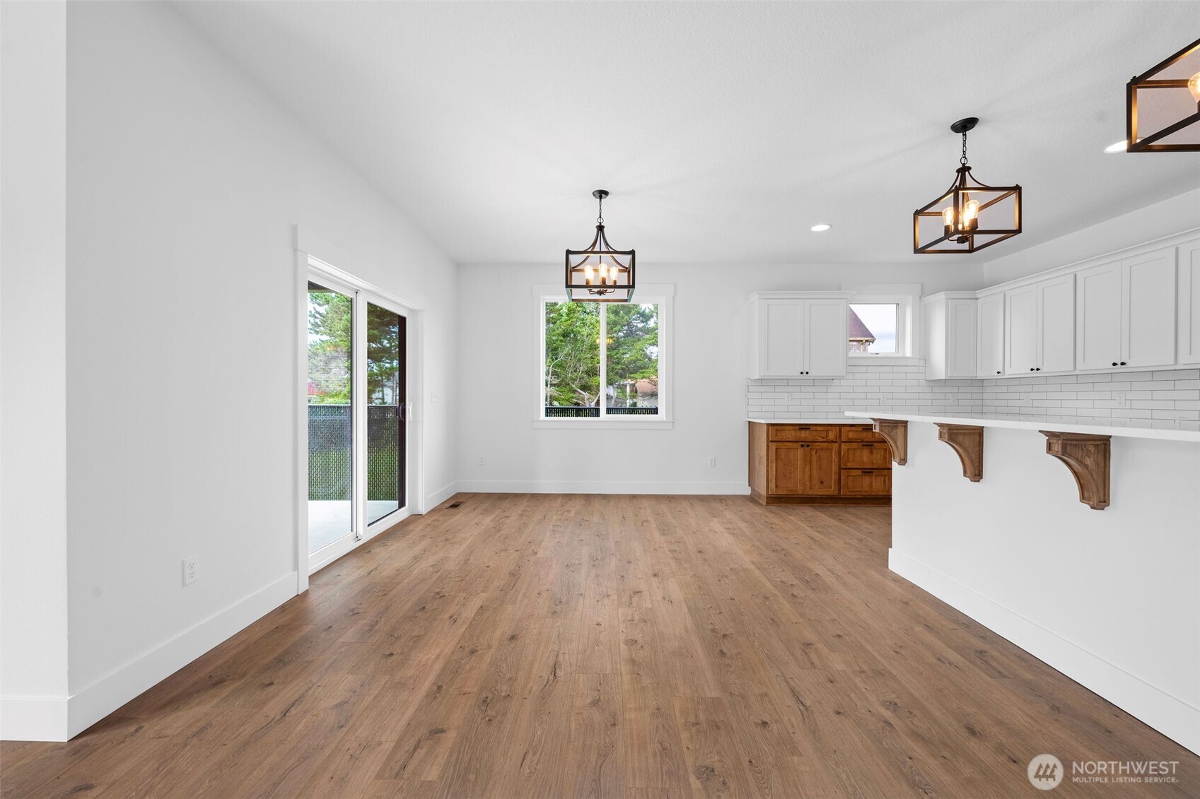 1306 195th Street Long Beach, WA 98631 - Photo 6 of 24 a view of a kitchen with wooden floor electronic appliances and windows