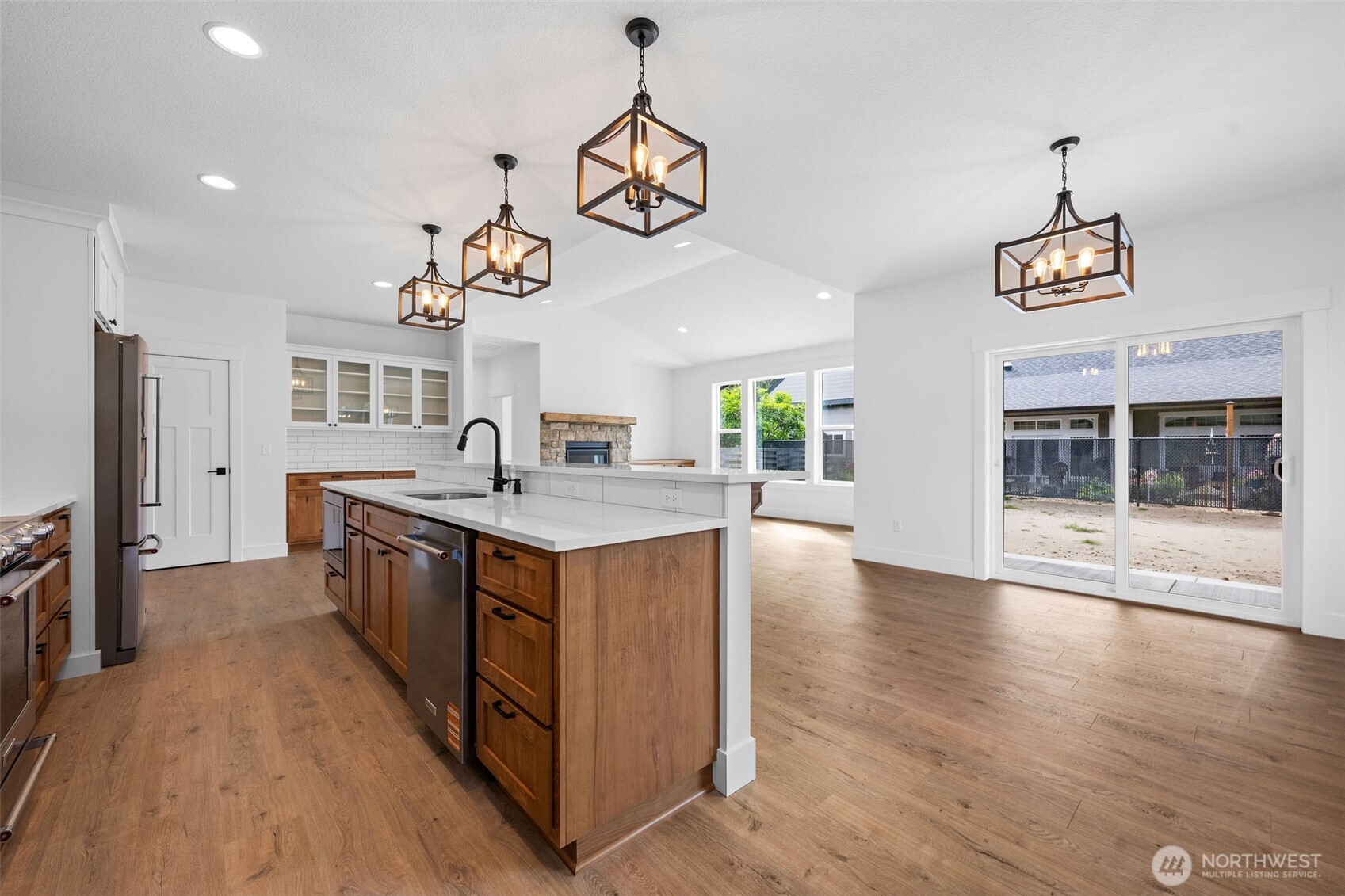 1306 195th Street Long Beach, WA 98631 - Photo 7 of 24 a kitchen with granite countertop a stove and a wooden floors