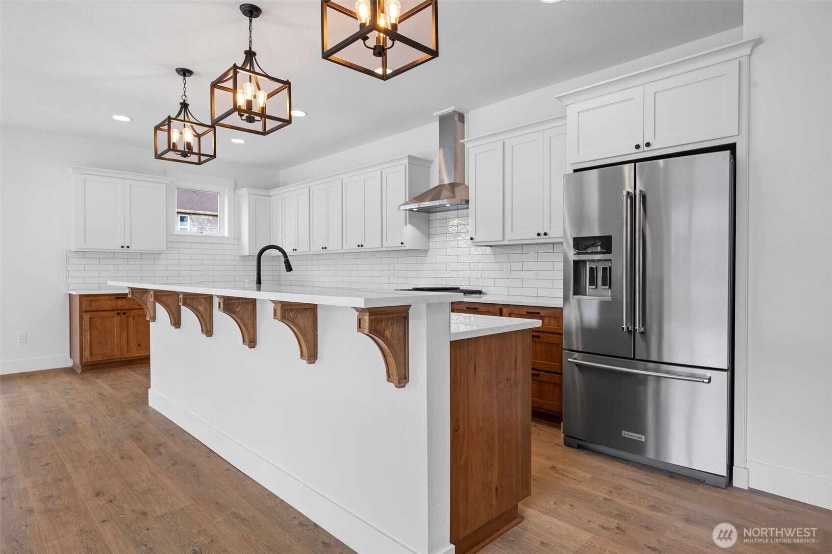1306 195th Street Long Beach, WA 98631 - Photo 8 of 24 a kitchen with kitchen island a counter space a refrigerator and cabinets