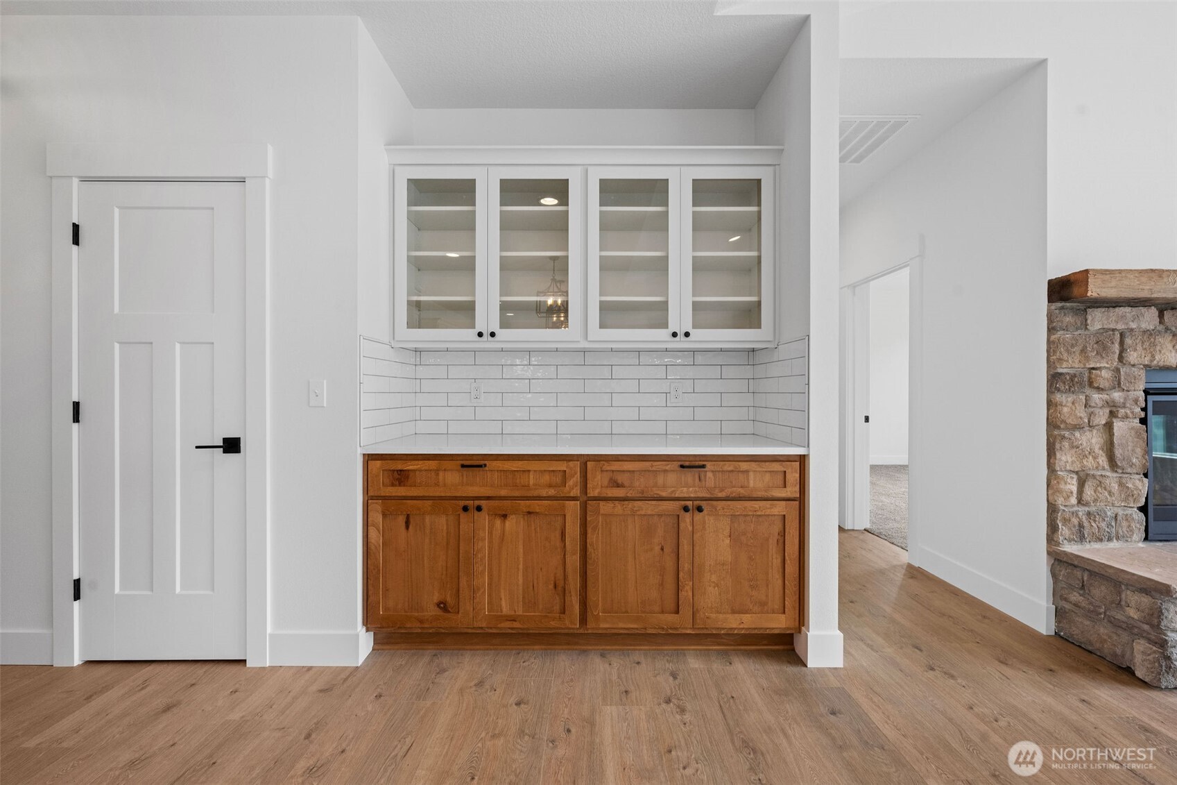 1306 195th Street Long Beach, WA 98631 - Photo 9 of 24 an empty room with wooden floor cabinet and windows