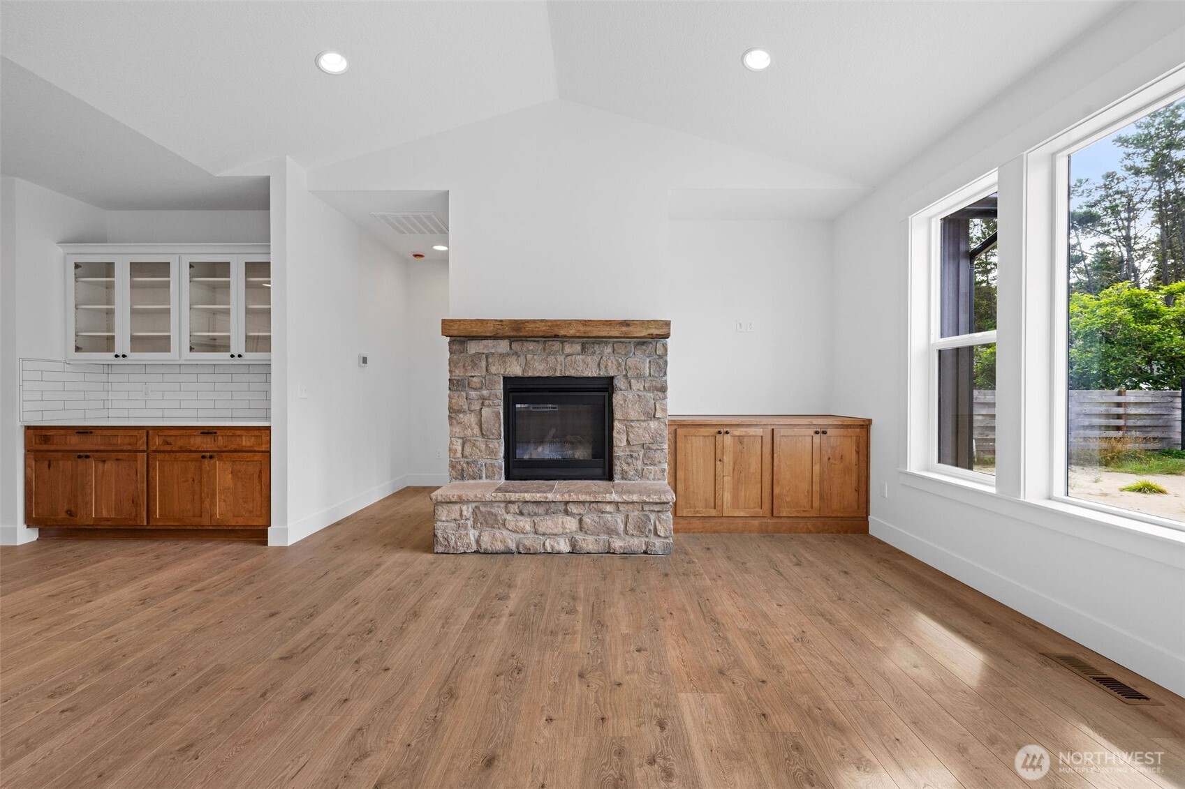 1306 195th Street Long Beach, WA 98631 - Photo 10 of 24 a view of empty room with wooden floor and fireplace