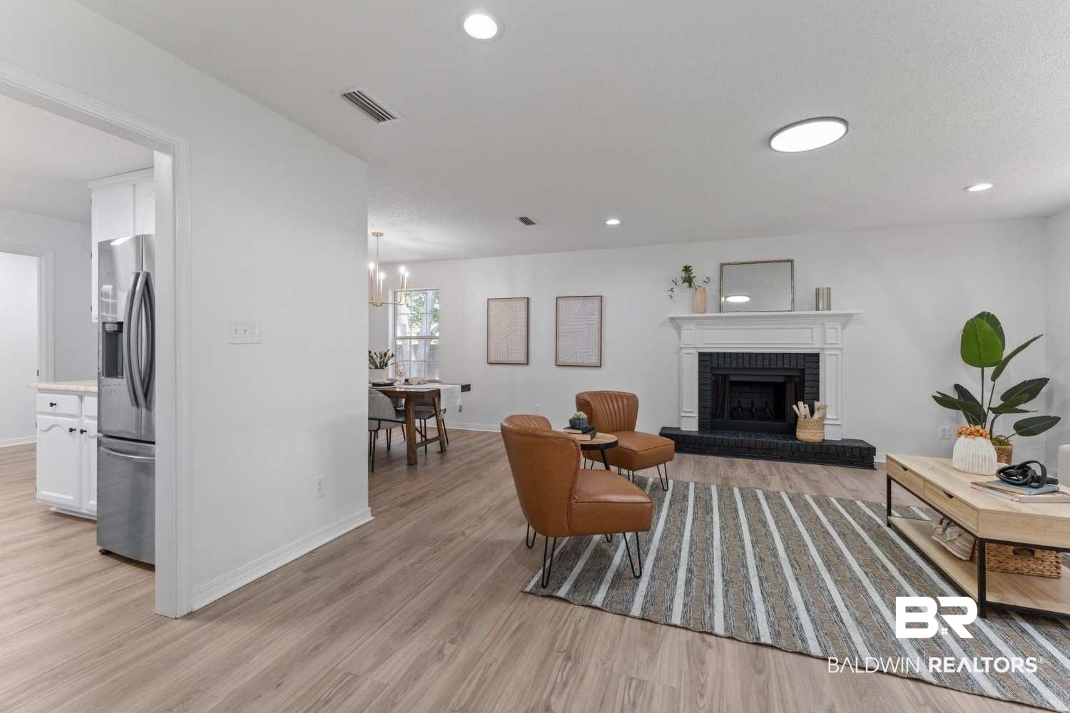 10251 Windmill Road Fairhope, AL 36532 - Photo 15 of 44 Living area featuring light wood-style floors, a fireplace, recessed lighting, and a chandelier