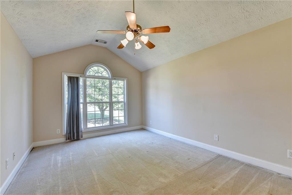 52 Katie Spring Lane Jefferson, GA 30549 - Photo 13 of 57 an empty room with chandelier fan and windows