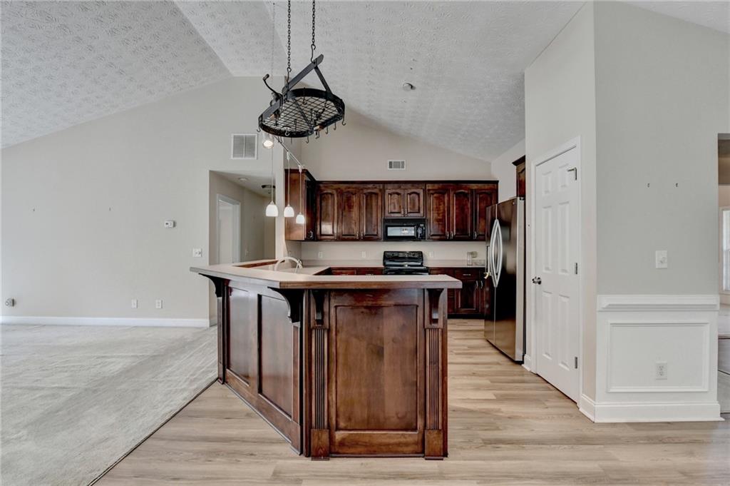 52 Katie Spring Lane Jefferson, GA 30549 - Photo 23 of 57 a kitchen with stainless steel appliances granite countertop a stove and a refrigerator