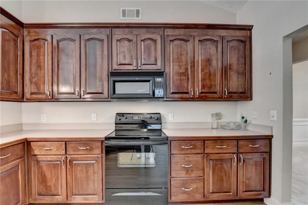 52 Katie Spring Lane Jefferson, GA 30549 - Photo 27 of 57 a kitchen with stainless steel appliances granite countertop a stove a sink and dishwasher with cabinets