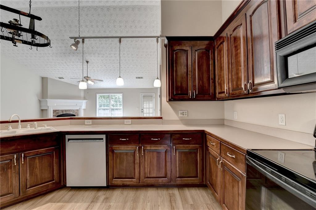 52 Katie Spring Lane Jefferson, GA 30549 - Photo 28 of 57 a kitchen with stainless steel appliances granite countertop a sink and cabinets