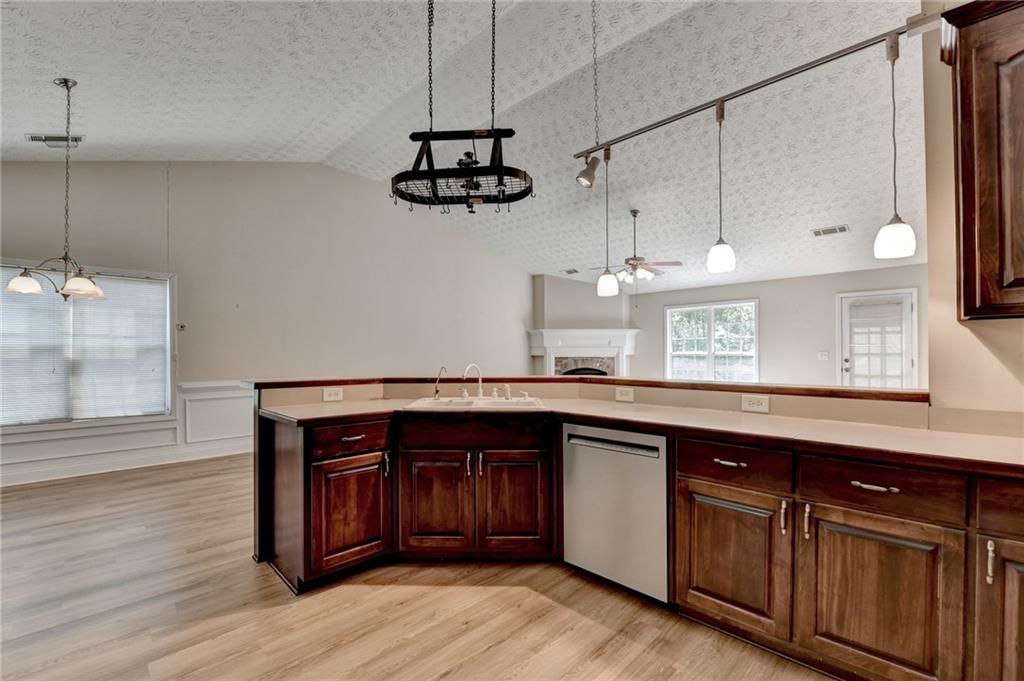 52 Katie Spring Lane Jefferson, GA 30549 - Photo 29 of 57 a kitchen with stainless steel appliances granite countertop a sink a stove and a wooden floors