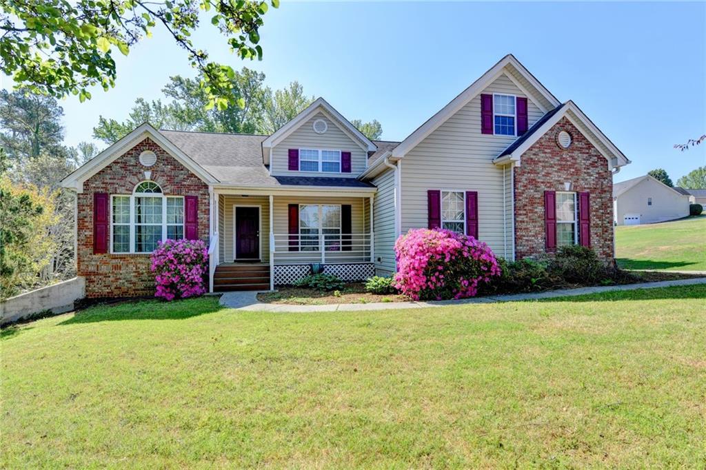 52 Katie Spring Lane Jefferson, GA 30549 - Photo 3 of 57 a front view of a house with a garden and porch