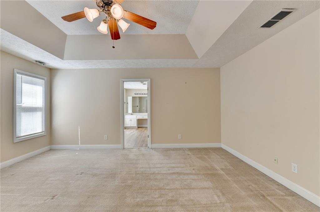 52 Katie Spring Lane Jefferson, GA 30549 - Photo 35 of 57 an empty room with chandelier fan and windows