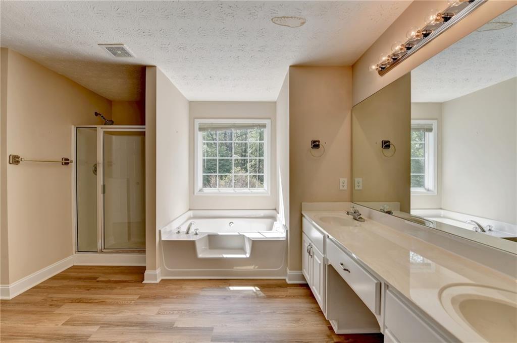 52 Katie Spring Lane Jefferson, GA 30549 - Photo 38 of 57 a spacious bathroom with a tub shower and sink