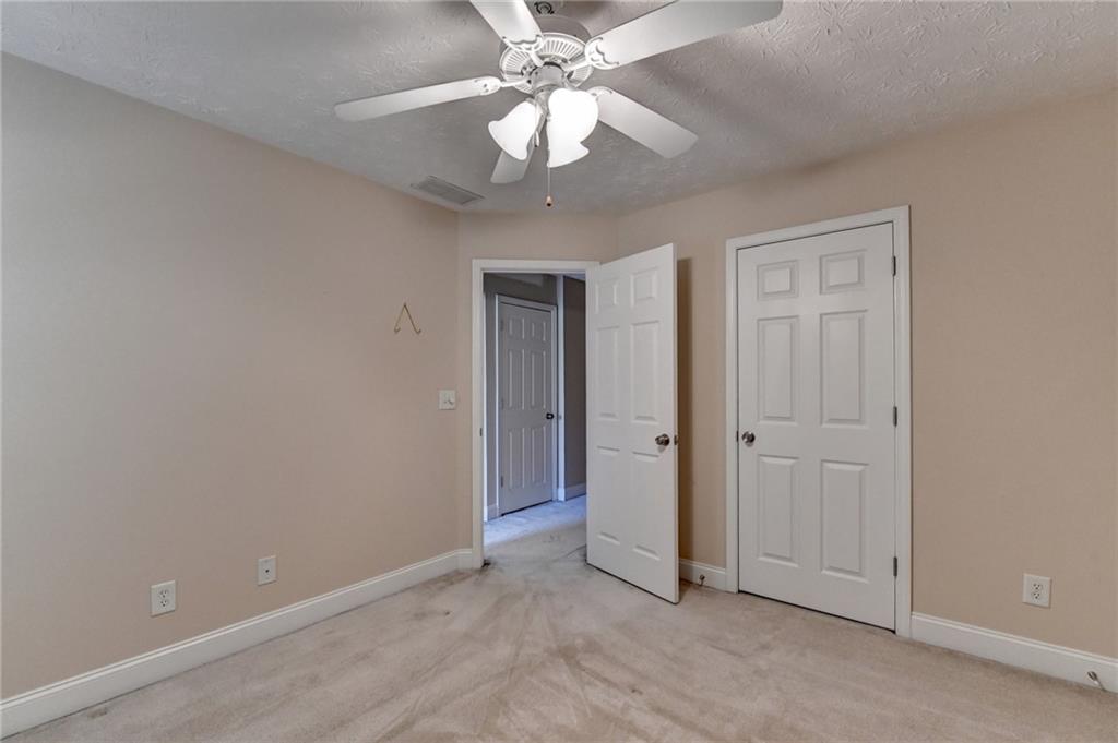 52 Katie Spring Lane Jefferson, GA 30549 - Photo 42 of 57 an empty room with a chandelier fan and closet area