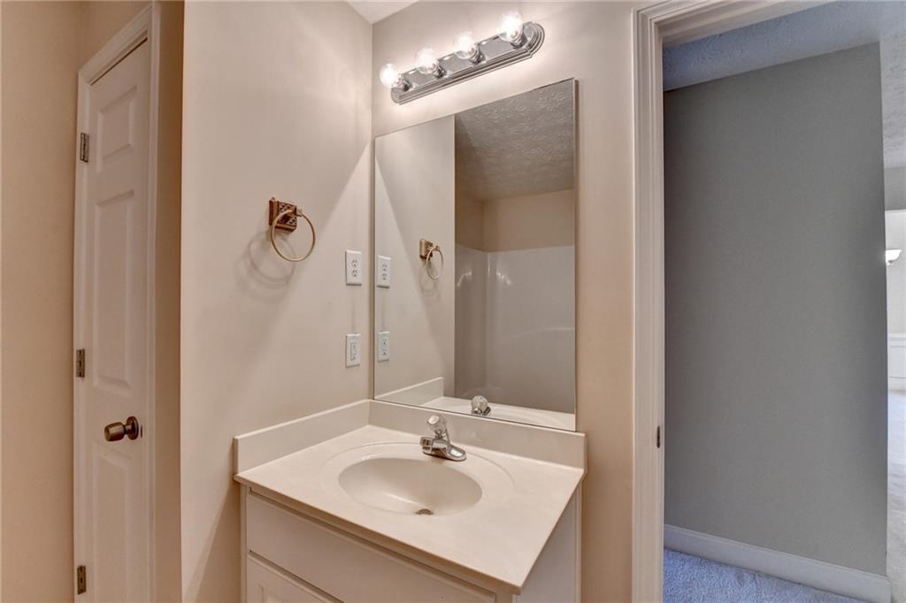 52 Katie Spring Lane Jefferson, GA 30549 - Photo 43 of 57 a bathroom with a sink a mirror and shower