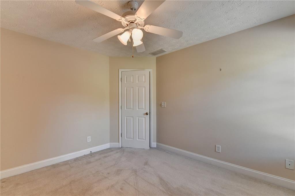 52 Katie Spring Lane Jefferson, GA 30549 - Photo 45 of 57 an empty room with a chandelier fan