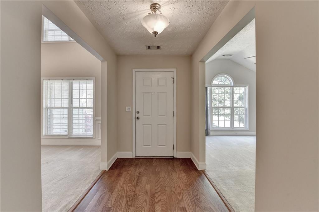 52 Katie Spring Lane Jefferson, GA 30549 - Photo 5 of 57 a view of an empty room with a window and wooden floor