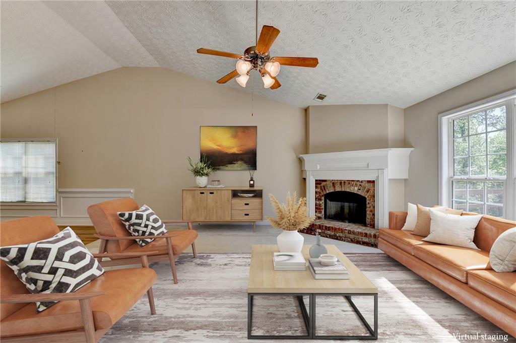 52 Katie Spring Lane Jefferson, GA 30549 - Photo 6 of 57 a living room with furniture a flat screen tv and a fireplace