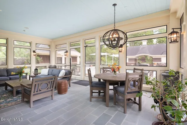 a front view of a house with swimming pool having outdoor seating