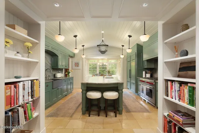 a dining room with furniture large windows and a chandelier