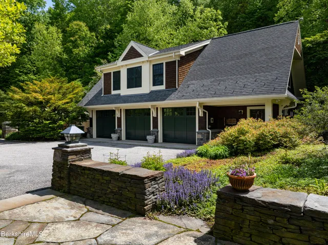 an aerial view of green landscape with trees houses and mountain view
