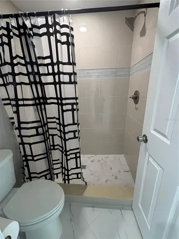 a white toilet sitting next to a bathroom sink