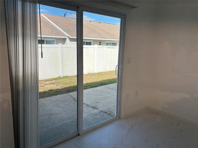 a view of an empty room with a fireplace