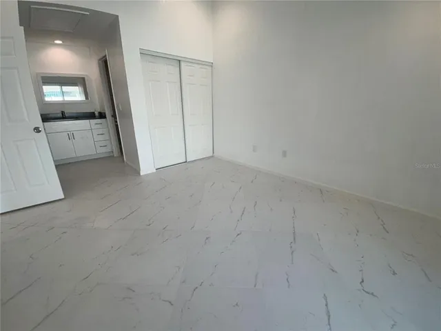 an empty room with a mirror and a sink