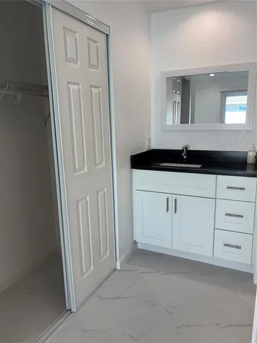 a bathroom with a sink a vanity and a mirror