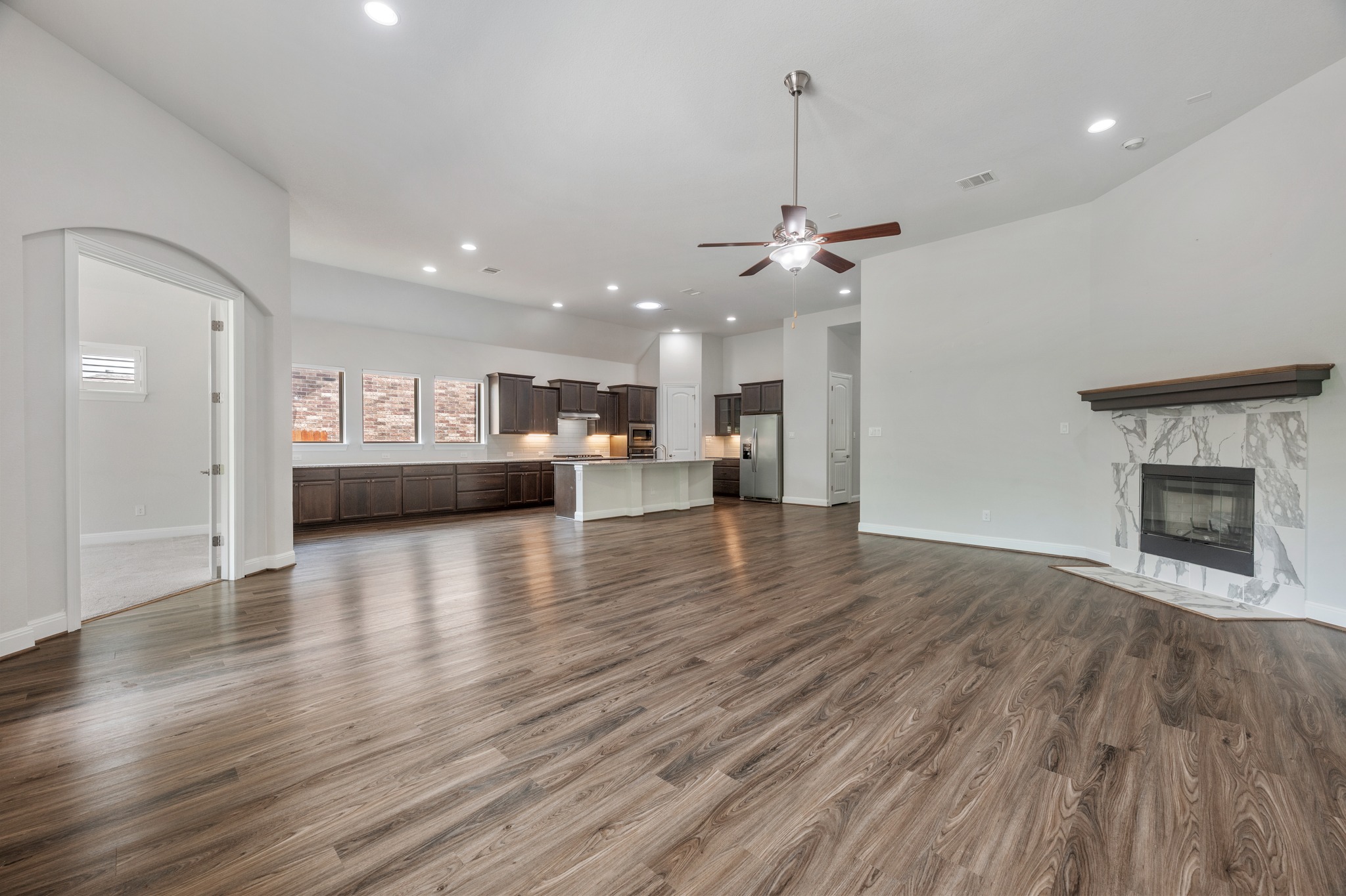 2709 Steece Way Leander, TX 78641 - Photo 11 of 39 a view of a kitchen with a ceiling fan wooden floor and a kitchen